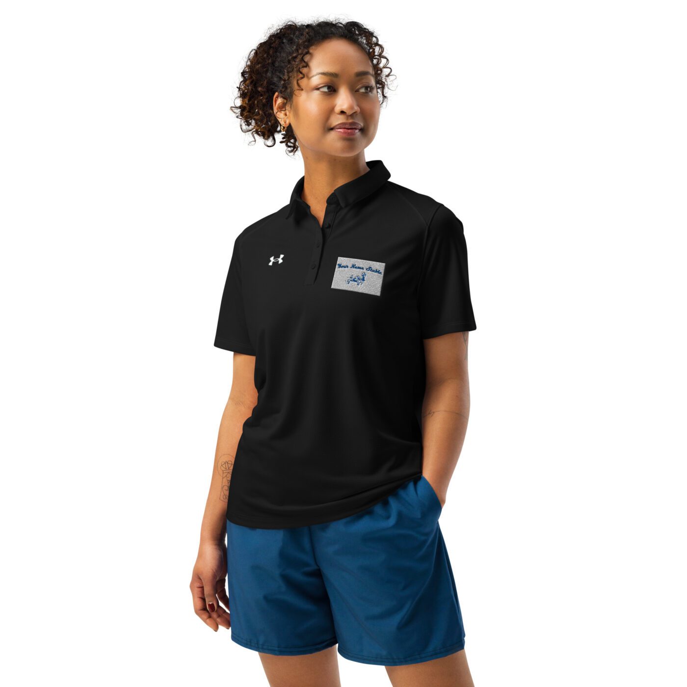 A woman wearing blue shorts and black shirt.