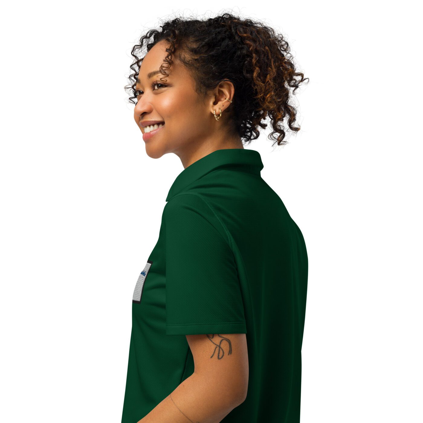 A woman with curly hair wearing a green shirt.