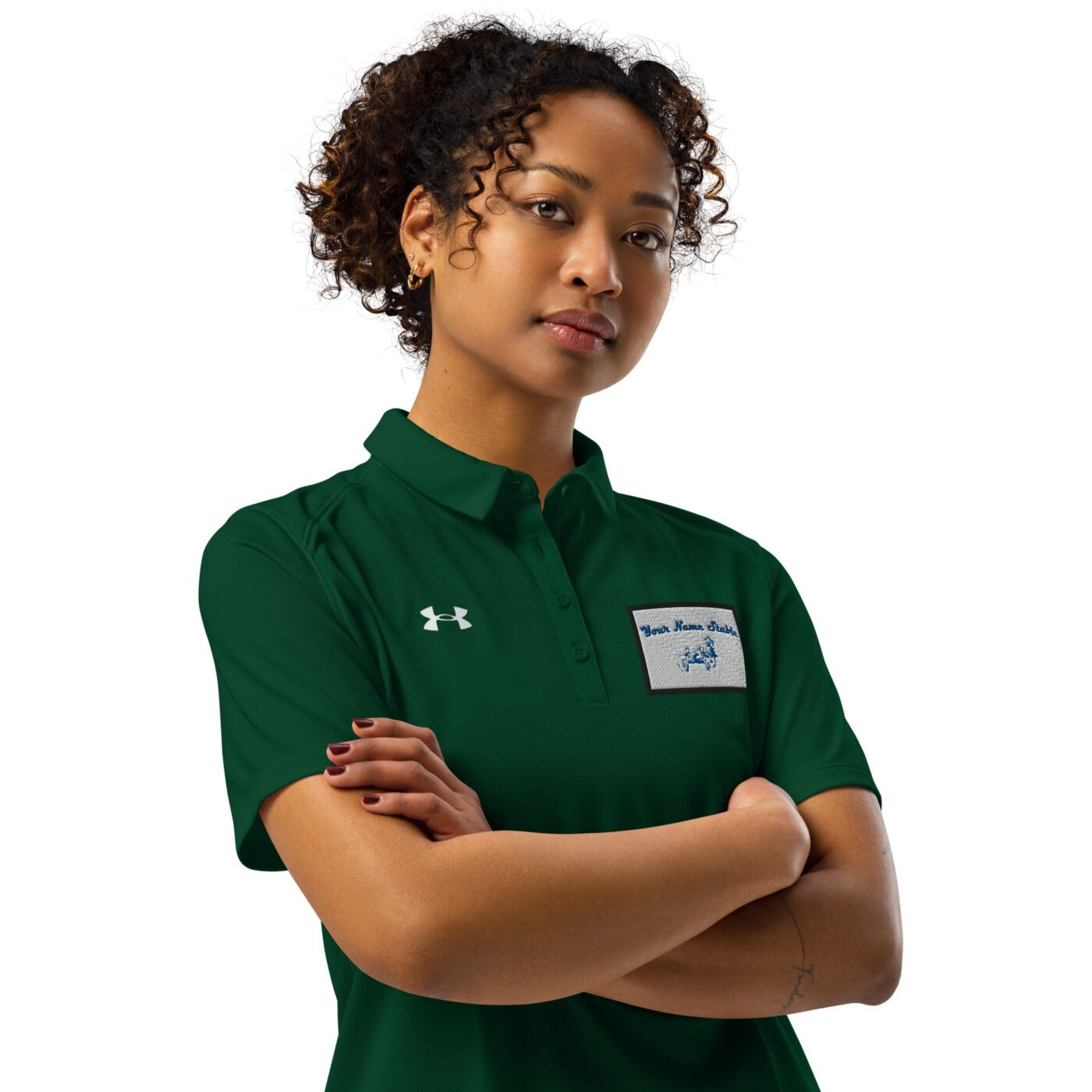 A woman in green shirt standing with arms crossed.