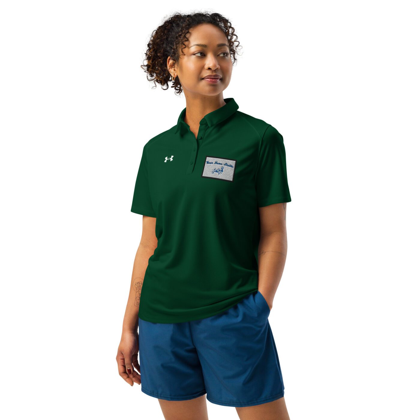 A woman wearing blue shorts and green shirt.