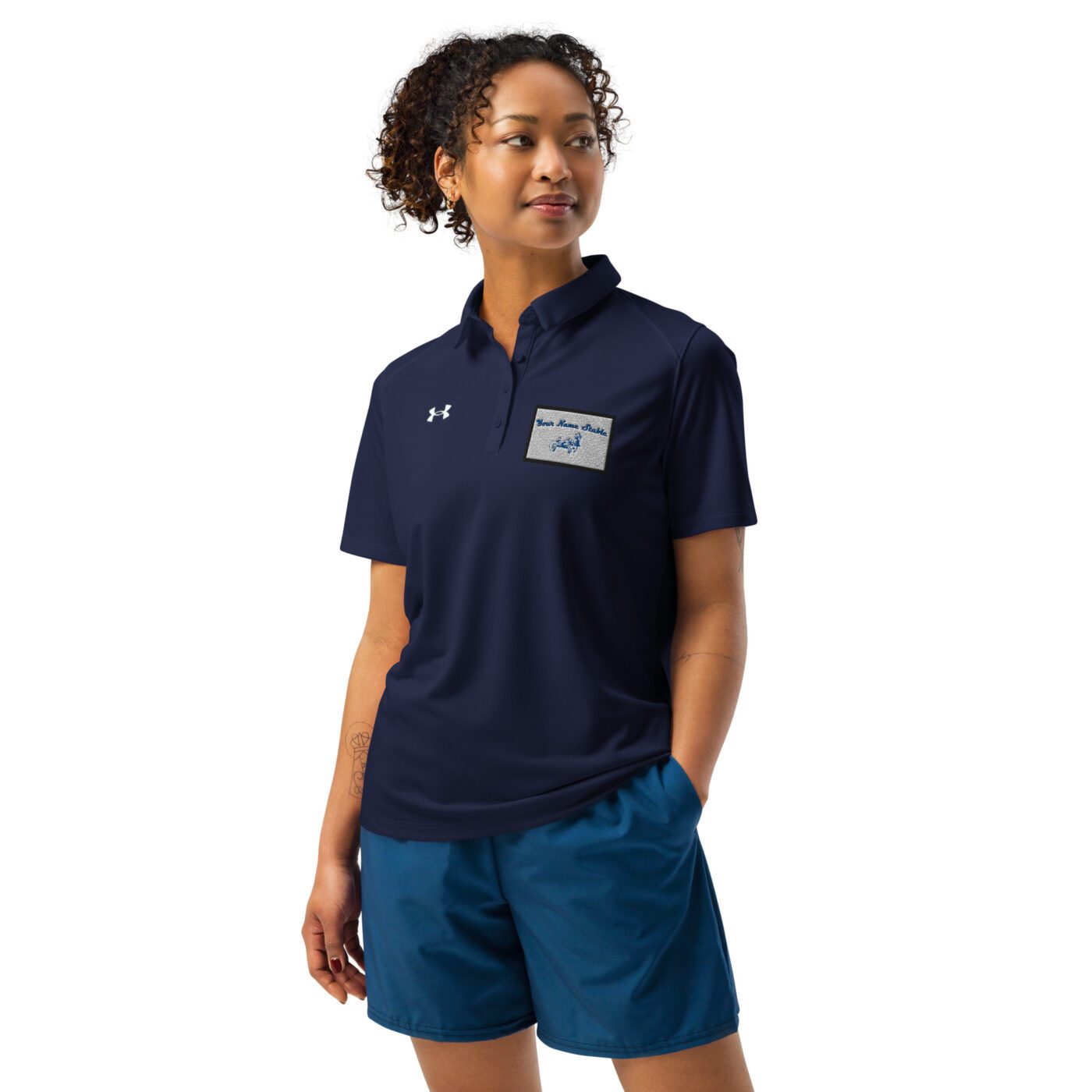 A woman wearing blue shorts and a polo shirt.