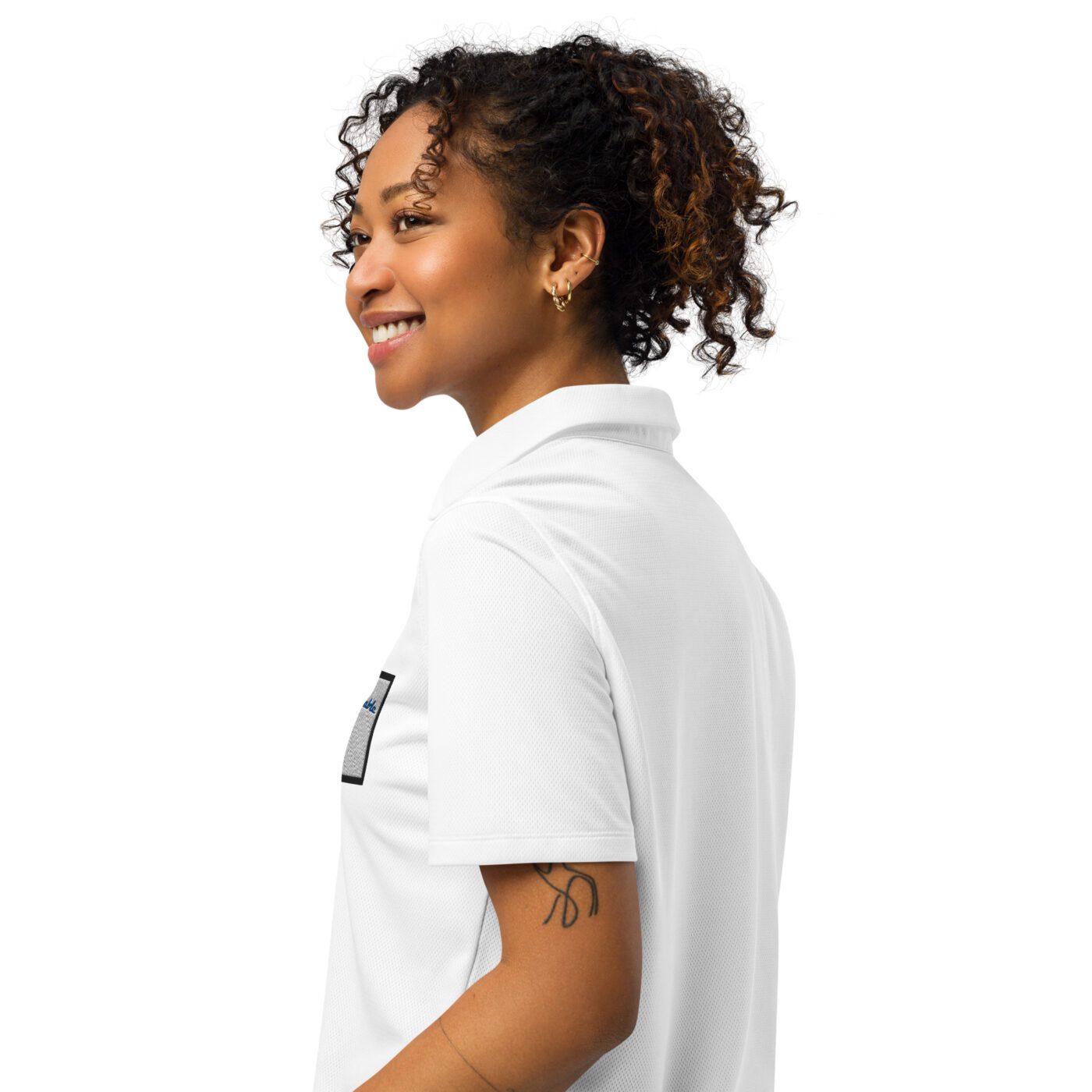 A woman with curly hair wearing a white shirt.