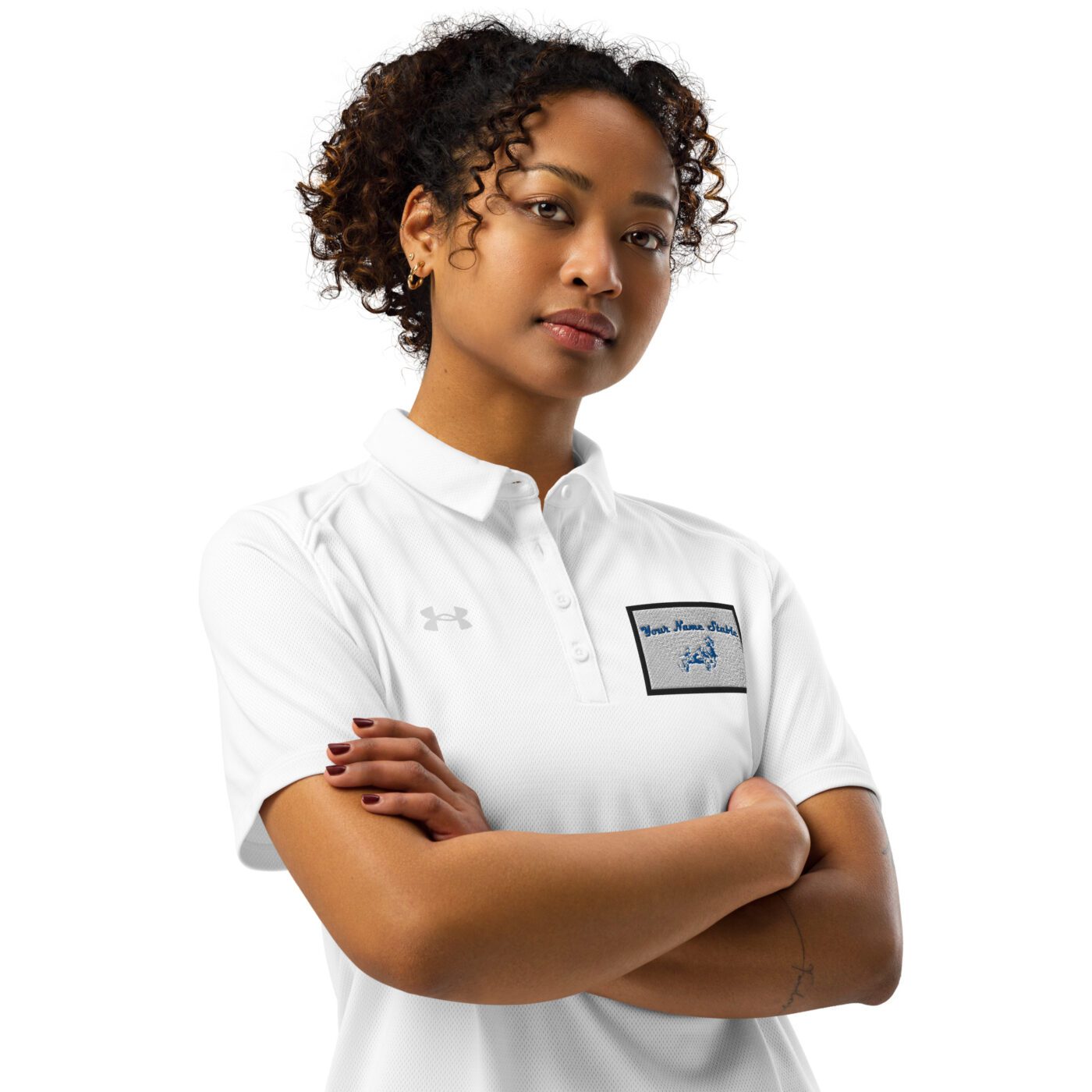 A woman in white shirt standing with arms crossed.