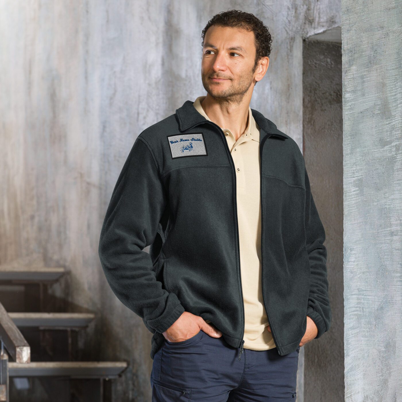 A man standing in front of some steps wearing a jacket.