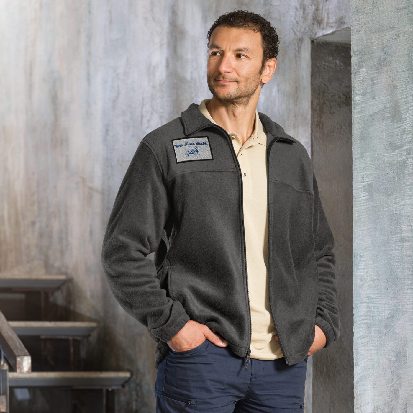 A man standing in front of some steps wearing a jacket.
